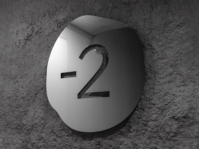 Mirror aluminium floor signage on a concrete wall